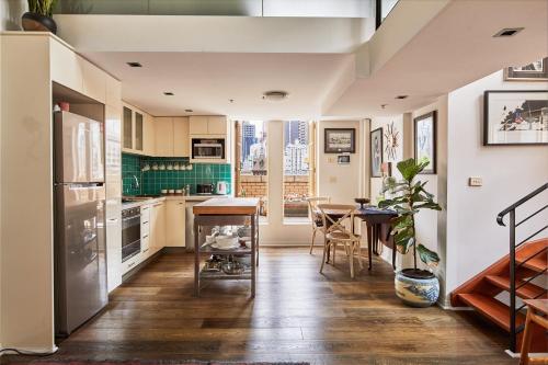 a kitchen with a table and a dining room at Deco Loft on Russell Street in Melbourne