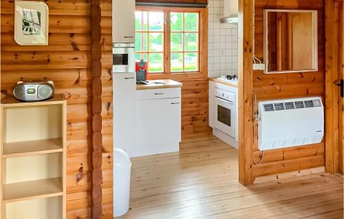 a kitchen with wooden walls and a white refrigerator at Mamet in Waldbillig