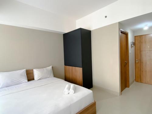 a bedroom with a bed with two white pillows on it at Good Choice and Cozy Studio Gateway Park LRT City Jatibening Apartment By Travelio in Bekasi