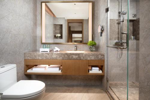 a bathroom with a sink and a shower at Holiday Inn Shunde by IHG in Shunde