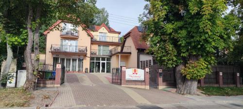 a large house with a sign in front of it at Villa Gdańsk in Gdańsk