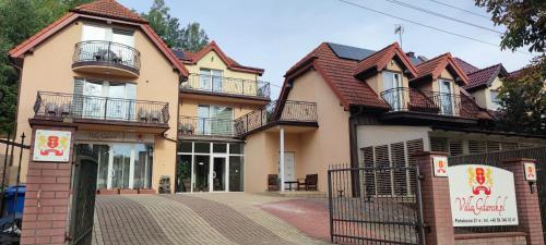 a large house with balconies on a street at Villa Gdańsk in Gdańsk