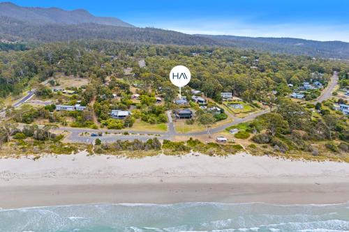 an aerial view of a beach with a sign that reads mkm at Sea views at Spring Beach Tasmanias East Coast in Spring Beach
