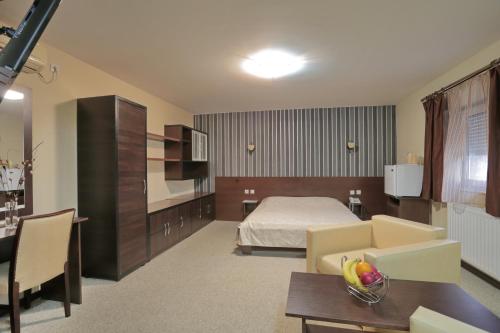 a hotel room with a bed and a living room at Motel Knez in Sombor