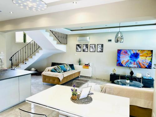 a living room with a couch and a table at Luxury Villa LAPIS LAZULI in Meneou