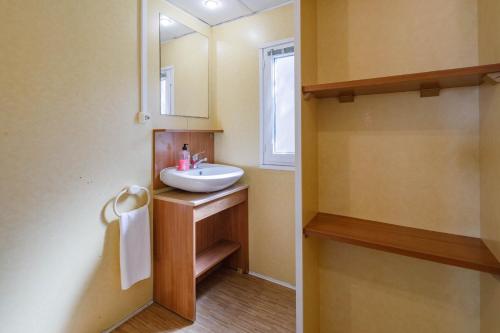 un baño con lavabo y espejo en Bungalow D, en Pontevedra