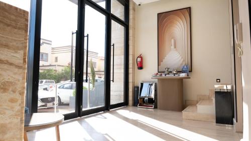 a living room with a large glass door at ركايا الوسطى للشقق المخدومة in Hail