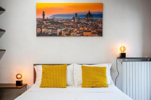 a bedroom with a bed with yellow pillows at "Once Upon A Time" Cherubini Palace Thematic Apartments Free Parking in Florence