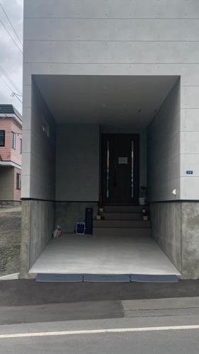 a building with a door and stairs in it at 楽Home in Otaru