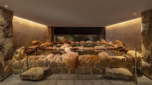 a large stone room with a display of rocks at 北投晶泉丰旅 Wellspring by Silks Beitou in Taipei