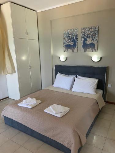 a bedroom with a bed with two towels on it at Sunset studio in Pefkohori