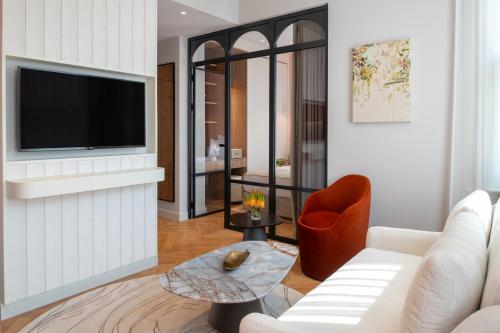 a living room with a couch and a tv at Casa Foscolo Hotel, Istanbul, a Member of Design Hotels in Istanbul