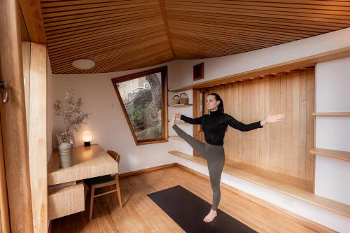 a woman is doing yoga in a room at The Bends House in Sandy Bay