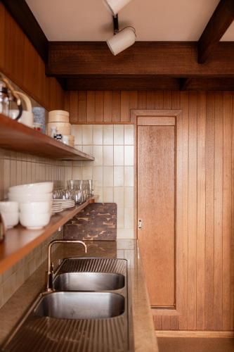 a kitchen with a sink and a counter top at The Bends House in Sandy Bay