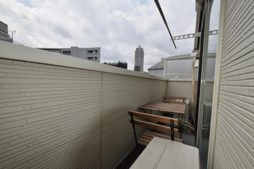 a balcony with a wooden bench on a building at TOKYO池袋家族連れ4DKの子供連れ５星　 in Tokyo