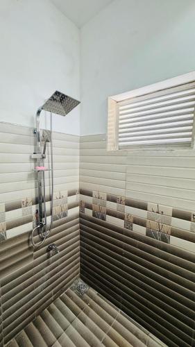 a shower in a bathroom with a window at Sunrise City Bliss in Sri Jayewardenepura Kotte