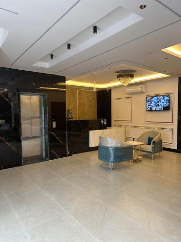 a living room with a couch and a table at The Crown Prince in Greater Noida