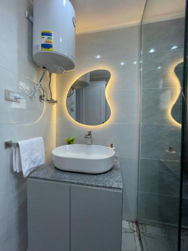 a bathroom with a sink and a mirror at Nadasha guest house cairo view in Cairo
