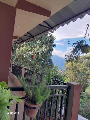 a balcony with a view of the mountains at Seven Hills Homestay in Kalimpong