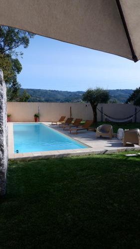 a swimming pool with lounge chairs next to at Eido do Luou - Casa de férias com piscina in Santa Cruz do Lima