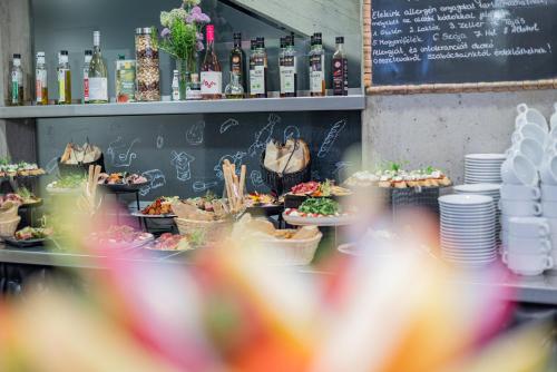 a buffet of food on display in a restaurant at Hotel Bonvino Badacsony in Badacsonytomaj