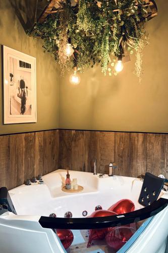 a large bath tub in a bathroom with at XiHouse Bed & Apartments - Iglesias in Iglesias