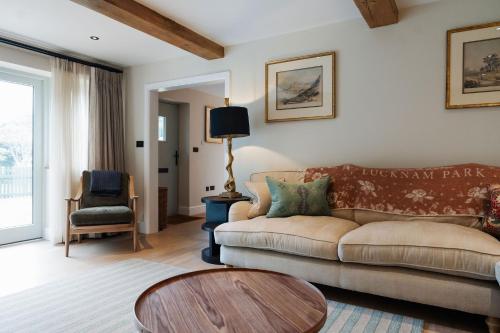 a living room with a couch and a table at Lucknam Park Hotel in Chippenham