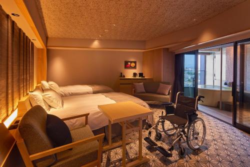 a bedroom with a bed and a wheelchair in a room at Yumoto Konpira Onsen Hananoyu Kobaitei in Kotohira