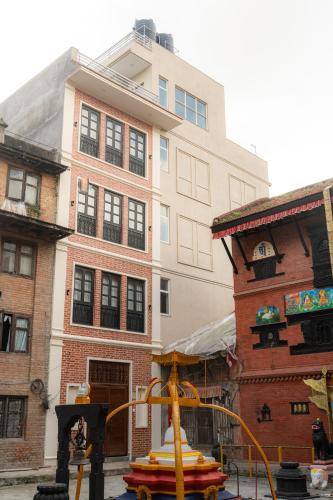 a building and a playground in front of a building at Maitreya Homestay in Pātan