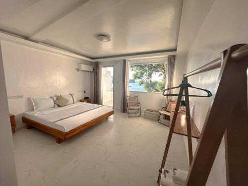 a bedroom with a bed and a tripod in a room at Krabs Dive Resort in Sabang