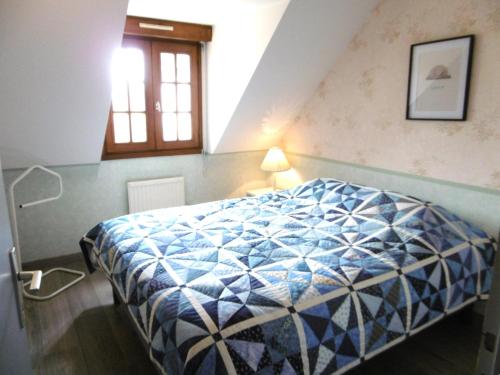 une chambre avec un lit avec une couette bleue et blanche dans l'établissement Maison 4 pièces 6 personnes proche de la mer - WIFI - SOAZIG, à Saint-Gildas-de-Rhuys
