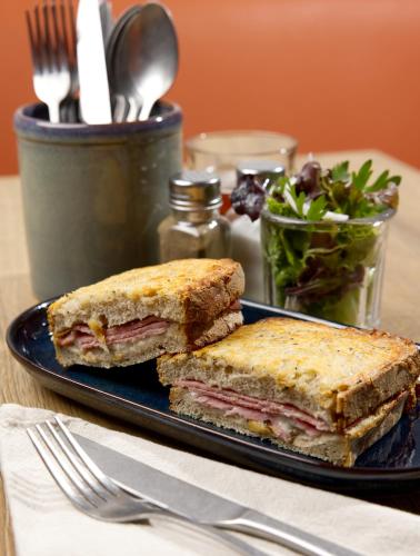 a sandwich cut in half on a plate on a table at Campanile NATURE - Bordeaux Sud Pessac in Pessac