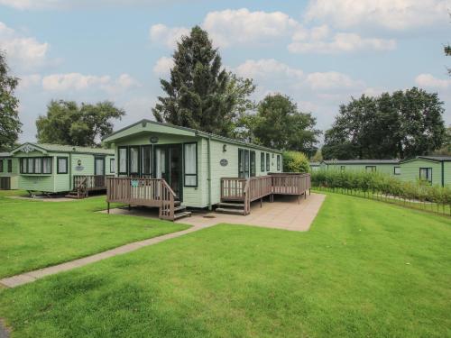 a row of green mobile homes in a park at Dove in Leominster