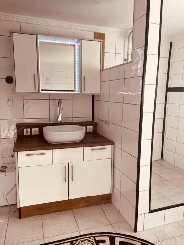 a bathroom with a sink and a shower at Appartement Sabrina in Steinberg am Rofan