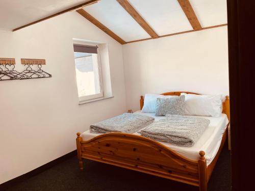 a bedroom with a wooden bed with a window at Appartement Sabrina in Steinberg am Rofan
