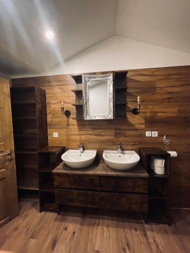 a bathroom with two sinks and a mirror at Appartement Sabrina in Steinberg am Rofan