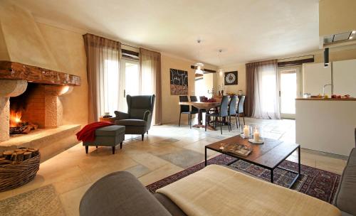 a living room with a couch and a fireplace at Villa Benvenuti near Motovun for 8 people - pet friendly with salt - water pool in Kaldir