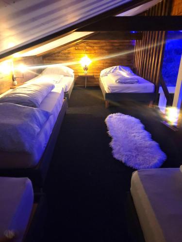 a room with three beds and a rug at Appartement Sabrina in Steinberg am Rofan