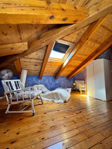 a room with a wooden ceiling with a chair in it at Hotel Rural La Encantada en Riaza in Becerril