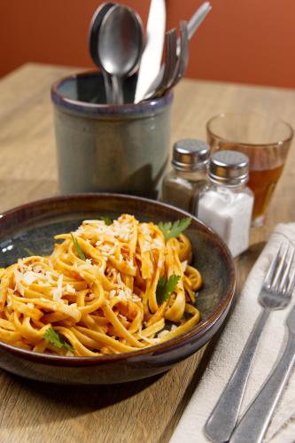 a plate of pasta with cheese on a table at Campanile NATURE - Bordeaux Sud Pessac in Pessac
