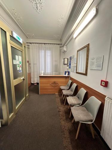 a waiting room with a row of chairs and a desk at Hotel Barone in Genova