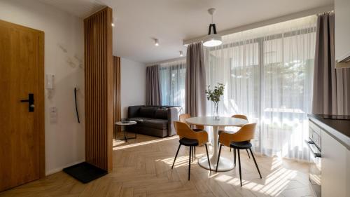 a kitchen and dining room with a table and chairs at Kalinowa z sauną, Sun & Snow in Szczyrk