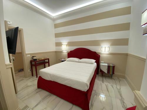 a bedroom with a red bed with a striped wall at Cozy Luxury Room Pantheon in Rome