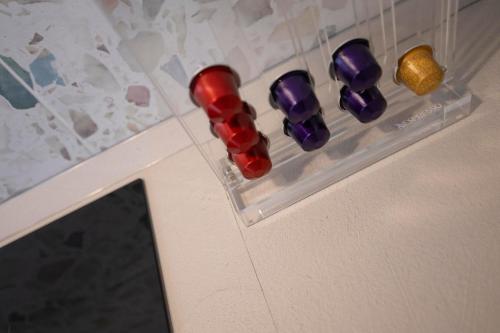 a row of red and purple balls on a wall at MyVilla - Ivrea via Rosselli 9 in Ivrea