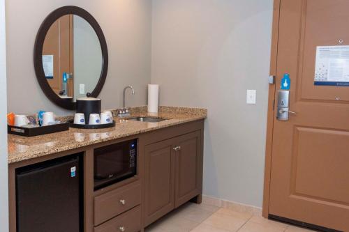 a bathroom with a sink and a mirror at Hampton Inn & Suites Riverton in Riverton