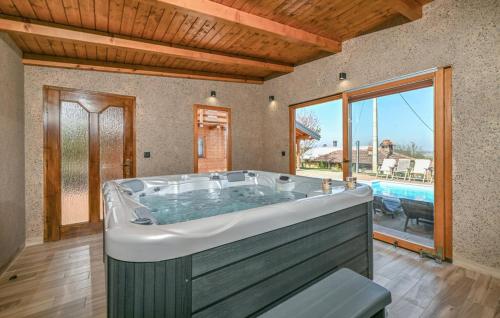 a large bath tub in a room with a pool at Vineyard Dream Villa in Vinogradi Ludbreski in Vinogradi Ludbreški