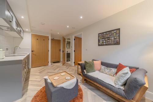 a living room with a couch and a table at Rock Mill - Deluxe 1-Bedroom Apartments in Stony Middleton