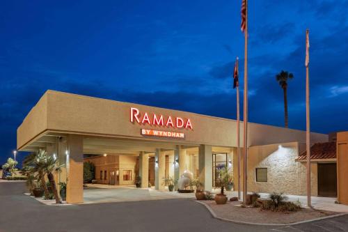 a rammada resort and convention center with a flag at Ramada by Wyndham Tucson in Tucson