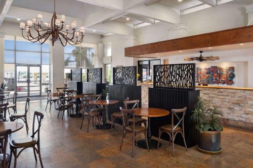a restaurant with tables and chairs in a room at Ramada by Wyndham Tucson in Tucson