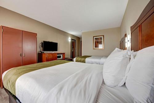a hotel room with two beds and a flat screen tv at Quality Inn near Mesa Verde in Cortez